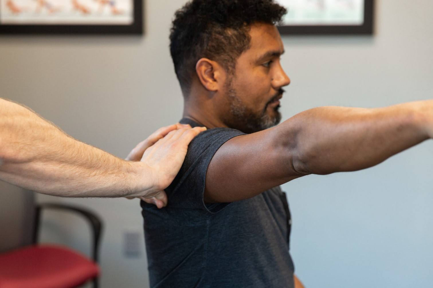 Soft tissue manipulation performed on the posterior shoulder of a man. 